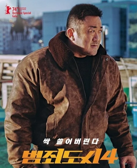 짧은머리의 갈색 가죽자켓을 입은 마독석이 주먹을 쥐고 오른쪽을 무섭게 보고있다.